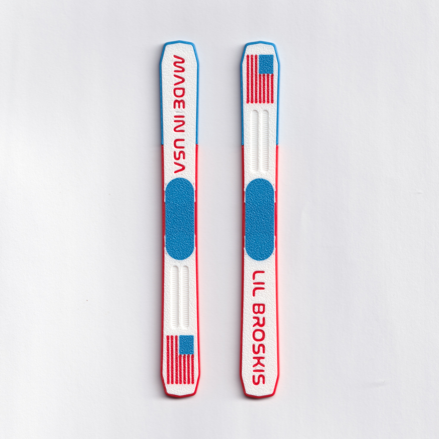 Two red, white, and blue skis with 'LIL BROSKIS' branding on a light gray background.